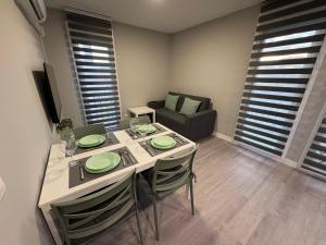 a dining room with a table and chairs and a couch at PUERTA De AGUILERA in Berlanga de Duero