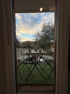 a view of a table through a glass door at PUERTA De AGUILERA in Berlanga de Duero