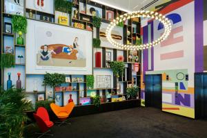 a lobby with colorful walls and chairs and a chandelier at citizenM Chicago Downtown in Chicago