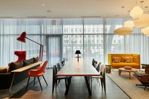 a dining room with a table and chairs at citizenM Chicago Downtown in Chicago