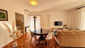 ein Wohnzimmer mit Tisch und Couch in der Unterkunft Villa Aleksandar Porec in Poreč