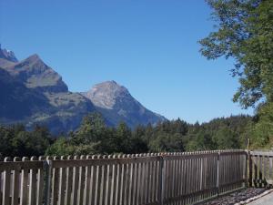 a wooden fence with a mountain in the background at Fewo Zenger Jossi in Hasliberg +9 photos