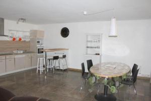 eine Küche mit Tisch und Stühlen in einem Zimmer in der Unterkunft Spacieux 4 pièces centre de mulhouse in Mulhouse + 7 Fotos