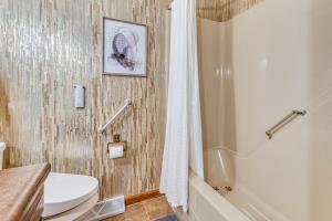 a bathroom with a white toilet and a shower at 4 Mi to Capitol Spacious Springfield Home with Deck in Springfield +29 photos