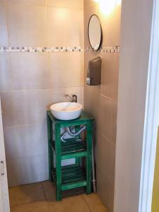 a bathroom with a green table with a sink at Parvis Magna HOSTAL in Barraquero +17 photos