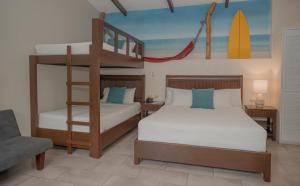 a bedroom with two beds and a bunk bed at Hotel Roca Sunzal in La Libertad +88 photos