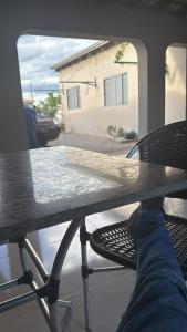 a person sitting at a table with their feet on it at Pousada novo mundo in Paulista