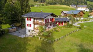 an aerial view of a house in a field at Ferienwohnung Haus Kipfen In Sibratsgfäll in Sibratsgfäll +7 photos