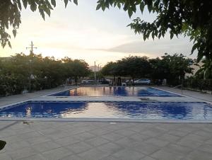 a swimming pool in the middle of a park at Casa Juli in Santa Marta