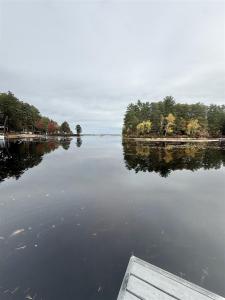 a view of a lake with a boat in the water at NORTHWEST EAGLE NEST LIMIT 9 home in East Sebago