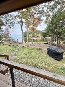a tent sitting on the grass next to a bench at NORTHWEST EAGLE NEST LIMIT 9 home in East Sebago +25 photos