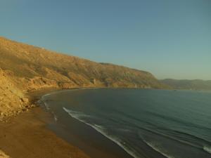 an aerial view of a beach with a mountain at tasurft house imsoune in Imsouane