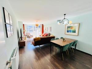 a living room with a table and a couch at Pradollano LUXUS Grandes vistas in Sierra Nevada