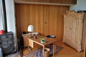 Zimmer mit einem Tisch, einer Lampe und einem Herd in der Unterkunft Auf einem großen Grundstück gelegenes Ferienhaus mit einer umwerfenden Panoramaaussicht in Glotzdorf + 32 Fotos