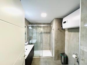 a bathroom with a shower and a toilet and a sink at Pradollano LUXUS Grandes vistas in Sierra Nevada +36 photos