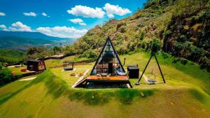 a boat sitting on top of a grassy hill at Chalé A-Frame - Chalé de Cima in Ouro Preto