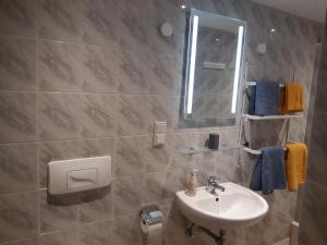 a bathroom with a sink and a mirror at Ferienhaus Würzgarte in Ürzig