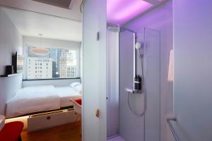 a bedroom with a bed and a shower in it at citizenM San Francisco Union Square in San Francisco +16 photos