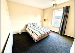 a bedroom with a bed and a window at Luxury Kingsize bedroom in a shared house in Chesterfield