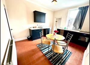 a kitchen with a table and chairs in a room at Luxury Kingsize bedroom in a shared house in Chesterfield