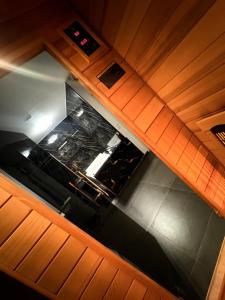 an overhead view of a kitchen with wooden cabinets at La Suite Gold Wellness Jacuzzi & Sauna in Seraing +15 photos
