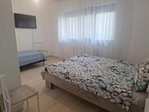 Postel nebo postele na pokoji v ubytování Apartament Sos Alexandriei Bragadiru + 8 fotografií