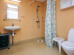 a bathroom with a toilet and a sink and a shower at 4 star holiday home in Hejls in Hejlsminde