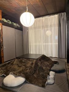 a living room with a table and a largeanimal at 一棟貸し宿 ｍａｉｃｃａ in Numazu +87 photos