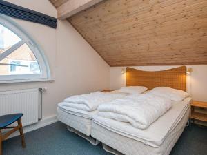 a large bed in a room with a wooden ceiling at 6 person holiday home in Rømø in Rømø Kirkeby