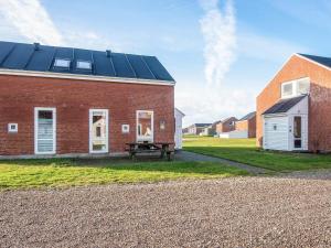 a red brick building with solar panels on it at 6 person holiday home in Rømø in Rømø Kirkeby