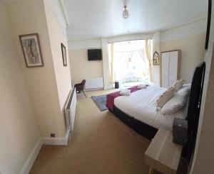 a bedroom with a large bed and a window at The Stokesay Inn in Craven Arms