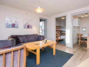a living room with a couch and a table at 6 person holiday home in Rømø-By Traum in Sønderby