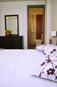 Ένα ή περισσότερα κρεβάτια σε δωμάτιο στο Sirocco