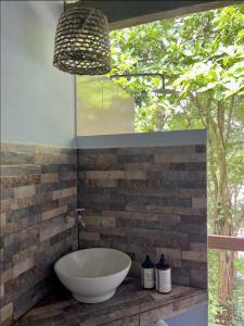 a bathroom with a bowl sink on a brick wall at Punta Brava in Nuquí +85 photos