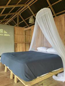 a bed with a mosquito net in a room at Punta Brava in Nuquí