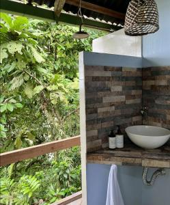 a bathroom with a sink in front of a forest at Punta Brava in Nuquí