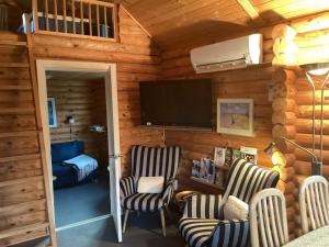 a living room with two chairs and a flat screen tv at 6 person holiday home in Hovborg-By Traum in Hovborg