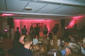 a crowd of people sitting in a room with pink walls at Balestrand Hotel in Balestrand