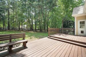 Majestic Home in Summer Oaks في أبيكس: سطح خشبي مع كرسيين على المنزل