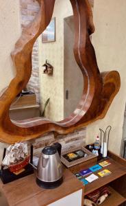 a wooden table with a mirror on a wall at Pousada Praia Dos Encantos in Japaratinga