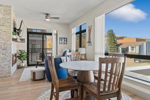 a dining room with a table and chairs at Skywalk Flats Mountainview Condo: Downtown, Rooftop Hot Tubs in Silverthorne