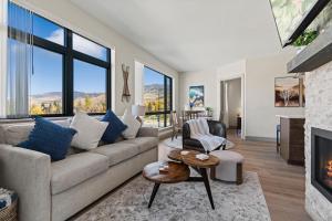 a living room with a couch and a fireplace at Skywalk Flats Mountainview Condo: Downtown, Rooftop Hot Tubs in Silverthorne