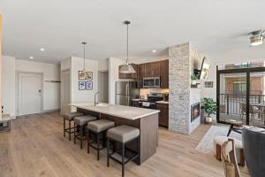 an open kitchen and living room with a large island at Skywalk Flats Mountainview Condo: Downtown, Rooftop Hot Tubs in Silverthorne