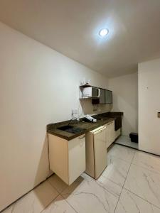 a kitchen with white walls and a counter top at 957 golden fortaleza frente mar in Fortaleza