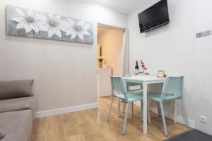 a living room with a table and chairs at Maison Grise in Setúbal