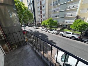 a balcony of a building with cars parked on a street at 2 Ambientes Gascon in Mar del Plata