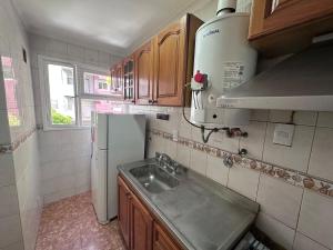 a kitchen with a sink and a refrigerator at 2 Ambientes Gascon in Mar del Plata