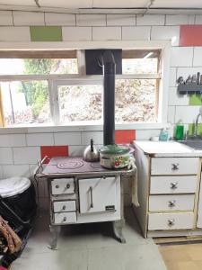 a kitchen with an old stove with a pot on it at La Casa de Sandrita in Castro +43 photos