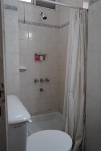 a bathroom with a tub and a toilet and a shower at Hotel coventry in Santiago del Estero