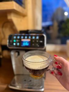 a woman holding a glass bowl on top of a table at Agroturystyka AKPólko in Biała Podlaska